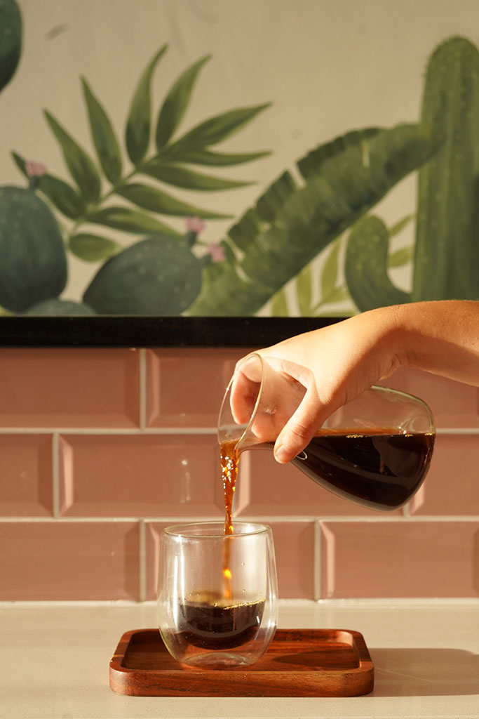 Coffee being poured from glass jug